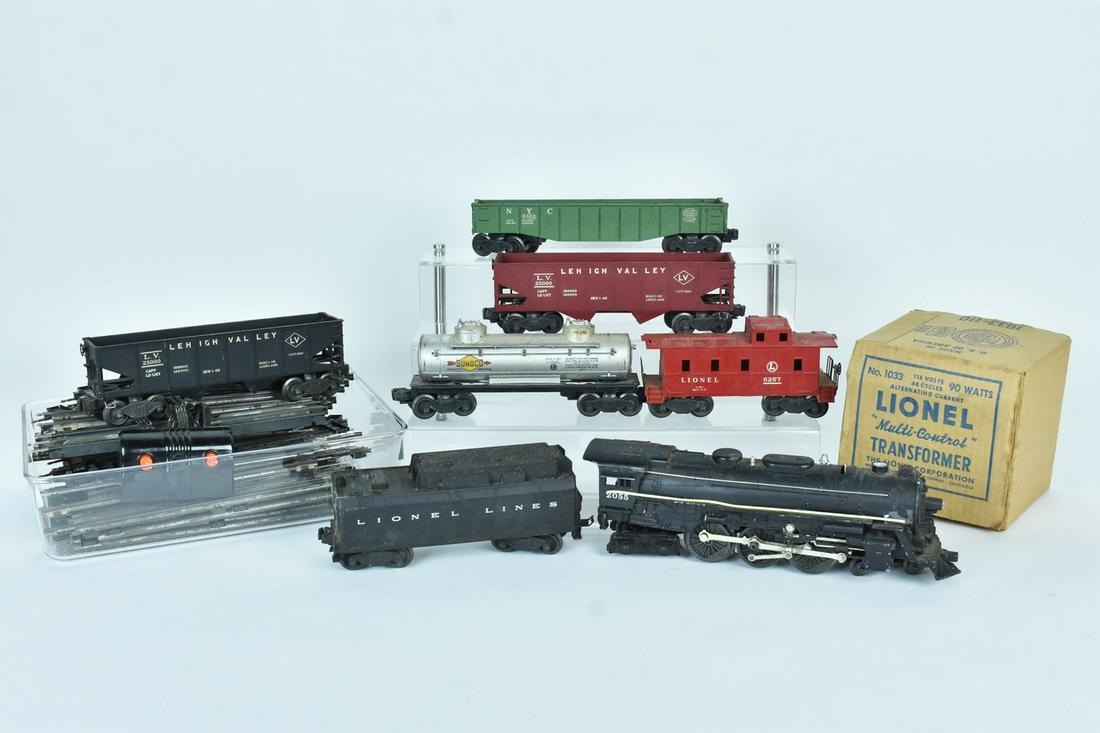 Lionel 2055 Steam Engine w/ Train Cars & Track: A Lionel 2055 steam locomotive with tender, a 6462 gondola, two 6456 hoppers, a 6465 Sunoco oil tanker, and a 6257 caboose. Also included are various pieces of track and a type 1033 transformer. Condi