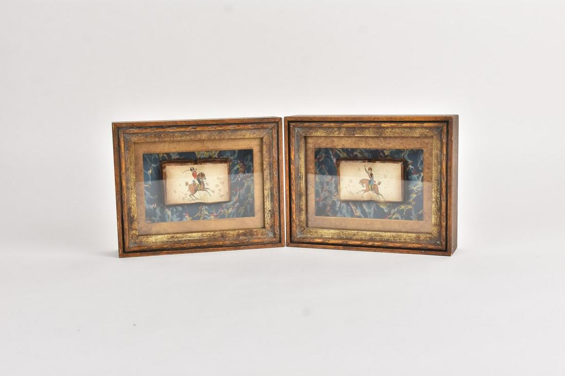 Antique Persian Inspired Miniature Books: A pair of shadowboxes featuring Persian inspired hand painted paper of soldiers on horseback pasted on top of a figurine shaped like a book. The book-like figurine is presented on top of marbled paper