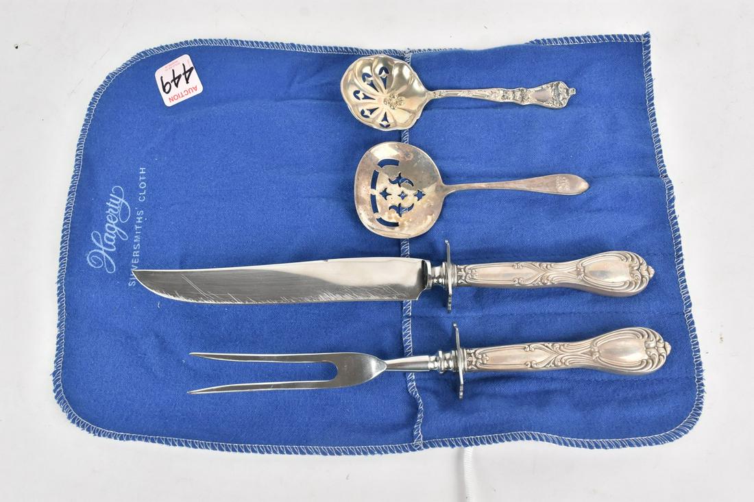 Sterling Silver Serving Utensils, 7.00 ozt: A collection of four sterling silver with an approx. total weight of 7.00 ozt. The collection includes a matching carving knife & fork and two pierced spoons. The carving knife measures approx. 10" lo