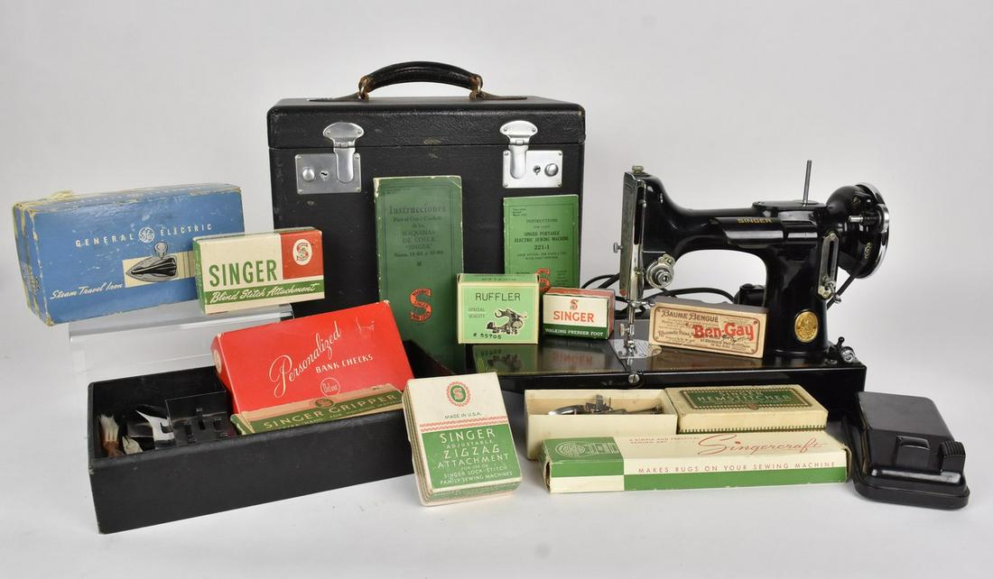 Singer 221 Featherweight Sewing Machine: A late 1930's SInger 221 featherweight sewing machine with original case and user manual. Serial Number AE-296744. Also includes accessories such as a ruffler, motor lubricant, steam travel iron and m
