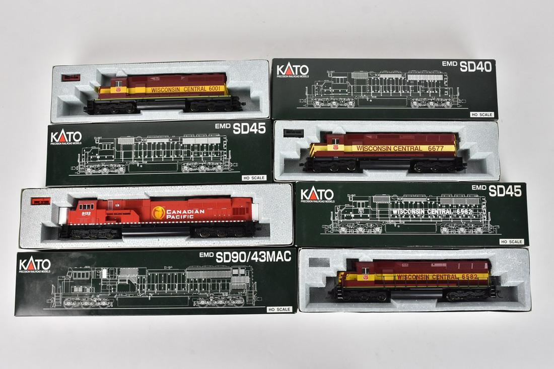 (4) Kato HO Scale Diesel Locomotives: A collection of four Kato Precision Railroad Model HO gauge Diesel Locomotive Engines in original packaging. Includes Wisconsin Central EMD SD-40; Canadian Pacific EMD SD90/43MAC; and more. Light shel
