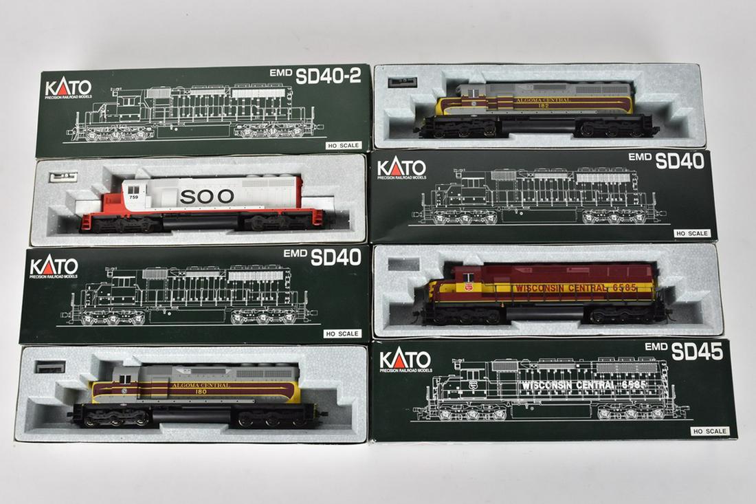 (4) Kato HO Scale Diesel Locomotives: A collection of four Kato Precision Railroad Model HO gauge Diesel Locomotive Engines in original packaging. Includes Algoma Central EMD SD40; Soo Line EMD SD40-2; and more. Light shelf wear to packag