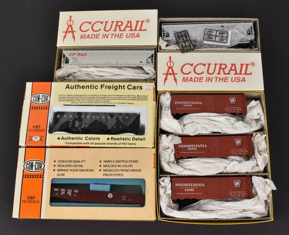 (5) Accurail & Con-Cor Model Train Kits: A collection of five HO scale Accurail and Con-Cor model train kits in original packaging. Includes a Pennsylvania Box Car 3-Pack; 3-Bay Hoppers; a Coal Hopper; and a Mill Gondola. Contents of packagi