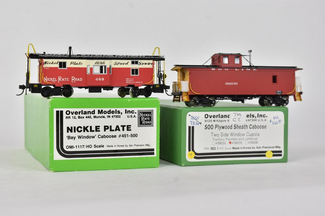 (2) Overland Models by AJIN (Korea): A pair of HO scale Overland Models by AJIN (Korea) trains in their original packaging; still wrapped in plastic. Includes Nickle Plate Bay Window Caboose and Soo Plywood Sheath Caboose. Light shelf we