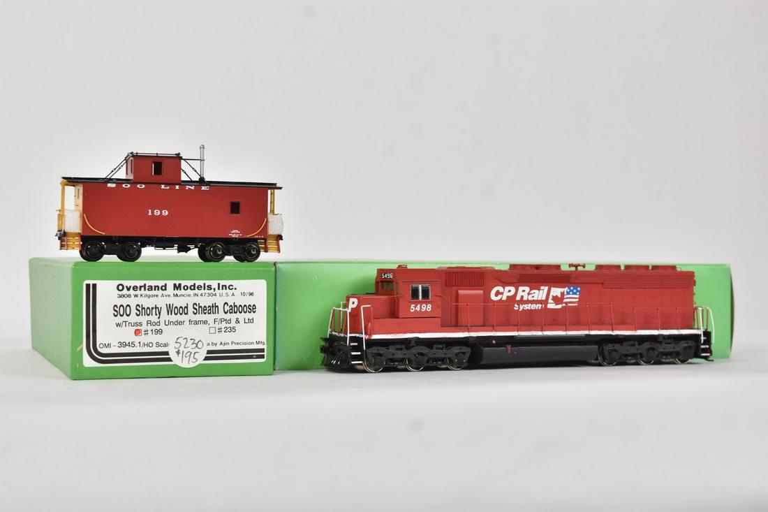 (2) Overland Models by AJIN (Korea): A pair of HO scale Overland Models by AJIN (Korea) trains in their original packaging; still wrapped in plastic. Includes a CP Rail System diesel engine; and a Soo Shorty Wood Sheath Caboose. Light sh