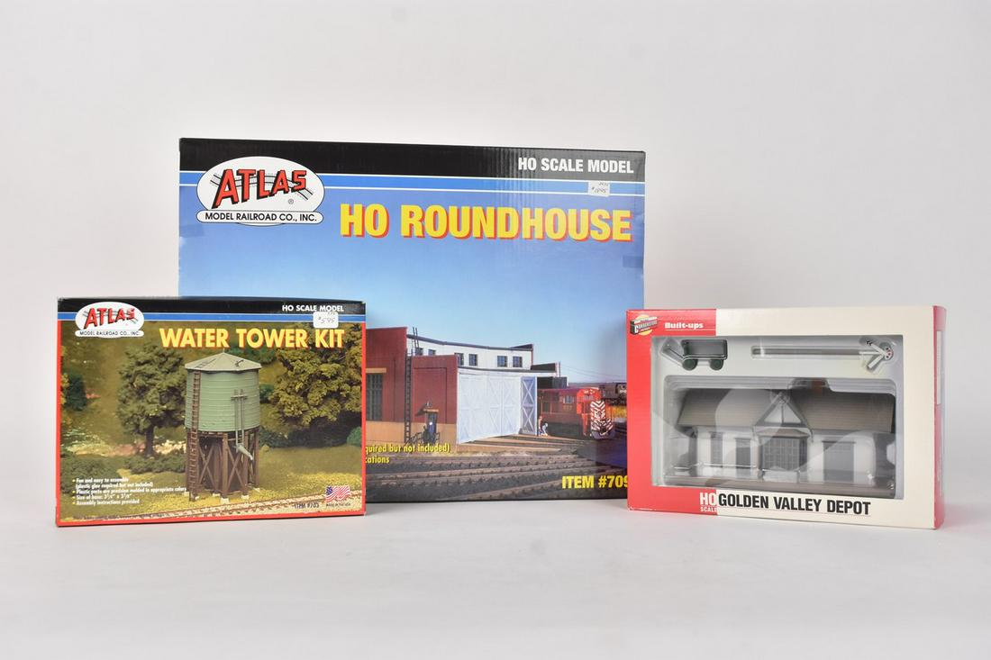 Atlas and Walthers Railroad Scenery Model Kits: A trio of railroad train scenery model kits in original packaging. Includes an Atlas #703 Water Tower Kit; a Cornerstone Series by Walthers Golden Valley Depot; and an Atlas #709 Roundhouse. Light she