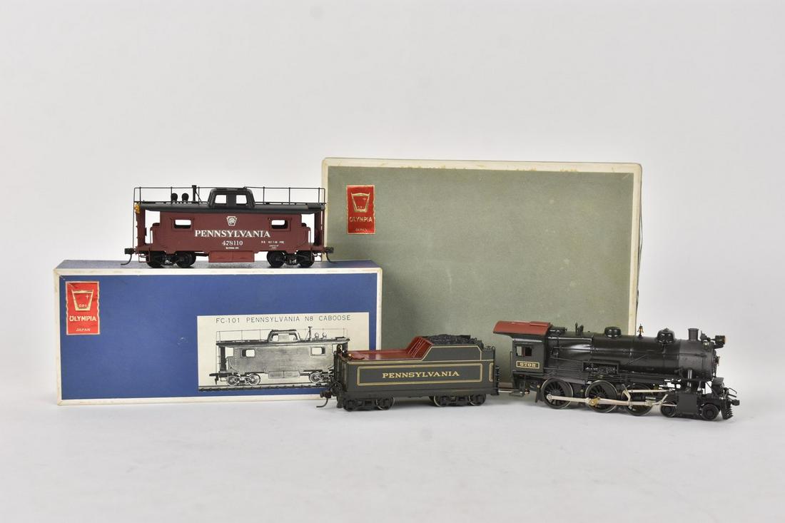 (2) Olympia Models Japan, Gem Models Trains: A pair of Olympia Precision Models Japan produced, Gem Models distributed HO scale trains in original packaging. Includes a Pennsylvania N8 Caboose and Pennsylvania R. R. Class G5S 4-6-0. Light shelf 