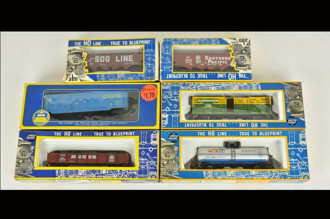(6) Ahm HO Scale Train Cars: A collection of six Ahm HO scale train cars in original packaging. Includes open hopper cars; a gondola; a cattle car; a tank car; and a box car. Heavy wear and tear to packaging; retail stickers. Ple