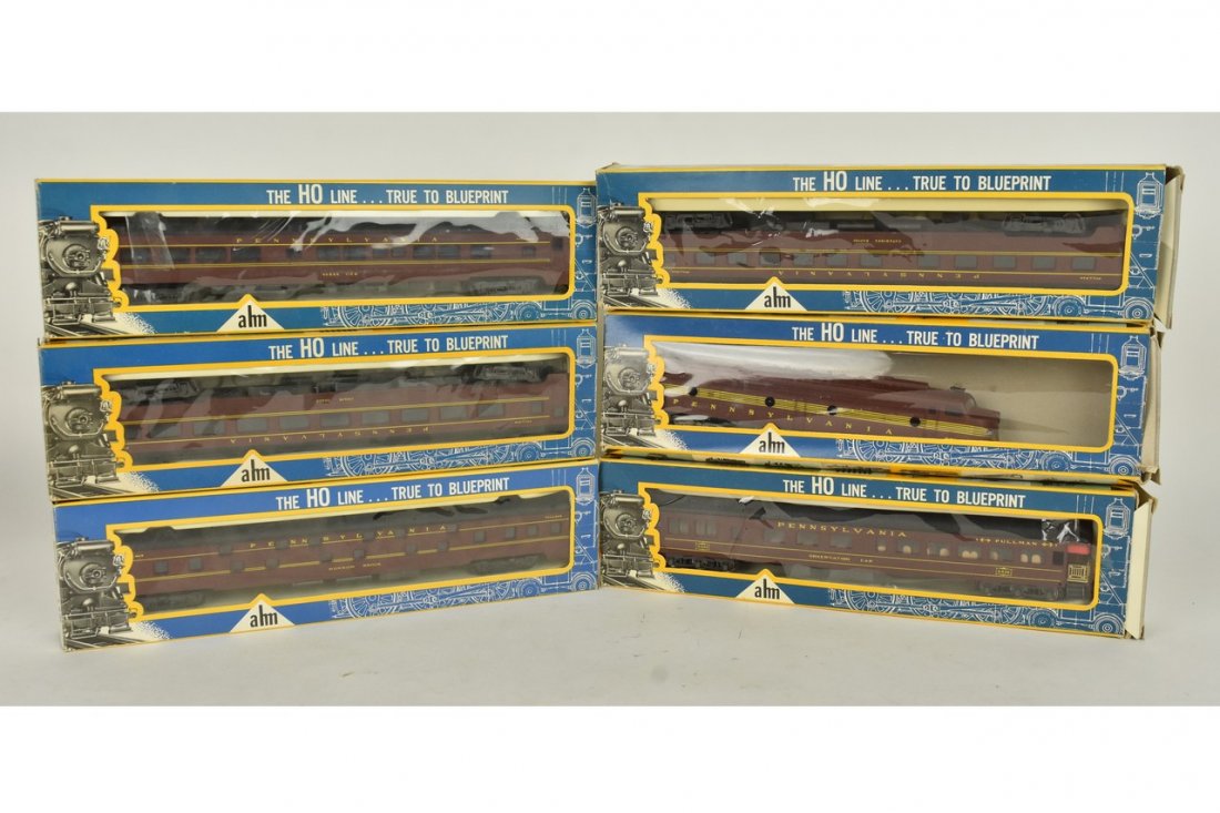 (6) Ahm HO Scale PRR Trains Incl. Engine: A 6-car Pennsylvania Railroad set including a G. M. Diesel E8 (E9) diesel engine. Also includes a coach, a sleeper car, a streamlined observation car, a streamlined sleeper, and an observation car. He