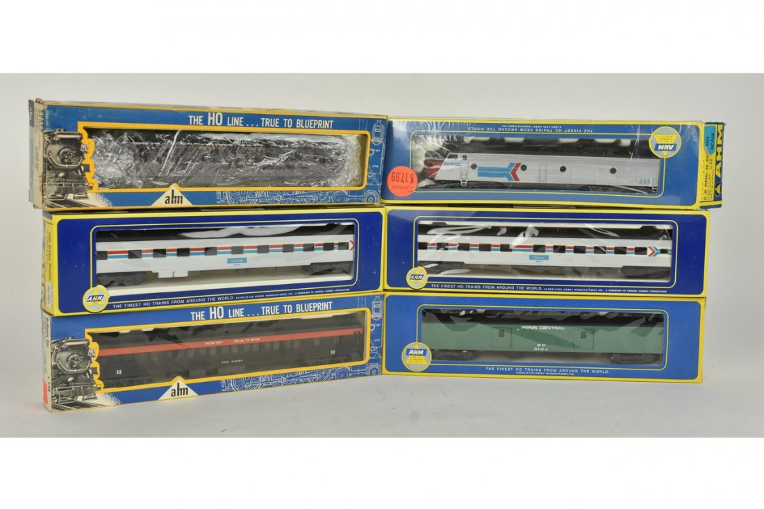 (6) Ahm HO Scale Passenger Train Cars: A collection of six Ahm HO scale passenger train cars including Amtrak. Wear and tear to packaging; retail stickers. Please Note: Scheerer McCulloch Auctioneer will add shipping charges 1-2 business d