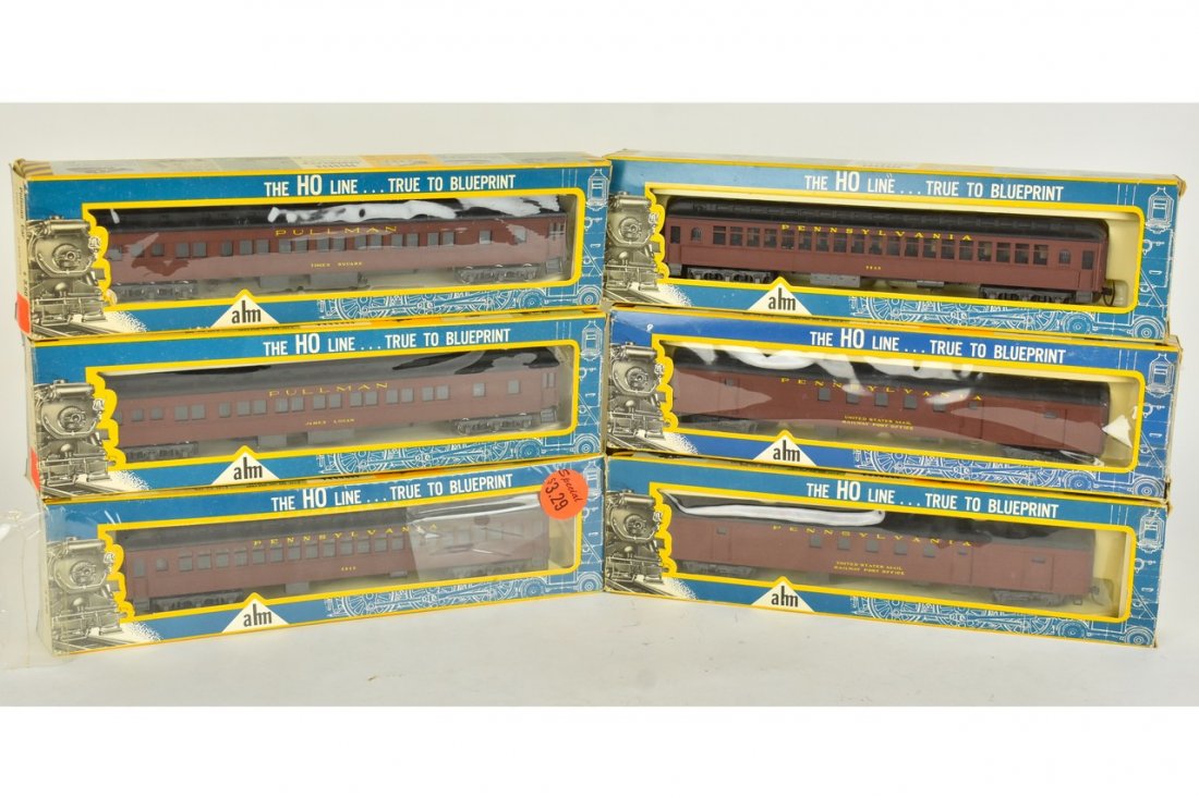 (6) Ahm HO Scale Passenger Train Cars: A collection of six Ahm HO scale Pennsylvania Railroad passenger train cars. Heavy wear and tear to packaging; retail stickers. Please Note: Scheerer McCulloch Auctioneer will add shipping charges 1-2
