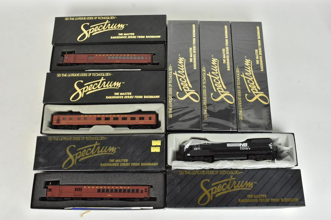 (7) Bachmann Spectrum HO Scale Trains: A collection of seven Bachmann Spectrum HO scale trains in original packaging. Includes passenger cars and a Dash 8 40C diesel engine. Light shelf wear to packaging; some retail stickers present. Plea