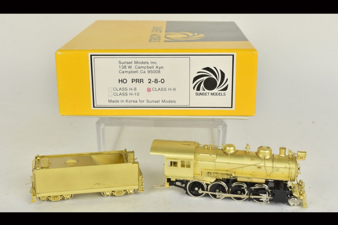 Sunset Models Brass PRR Locomotive & Tender: An HO scale Sunset Models brass H-9 Pennsylvania Railroad 2-8-0 locomotive with tender. In original packaging with light shelf wear. Please Note: Scheerer McCulloch Auctioneer will add shipping charge