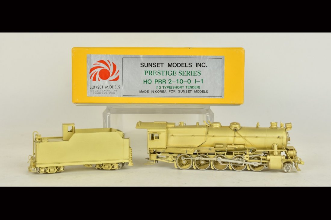 Sunset Models Brass PRR Locomotive & Tender: An HO scale Sunset Models Prestige Series brass I-1 Pennsylvania Railroad 2-10-0 locomotive with tender. In original packaging with light shelf wear. Please Note: Scheerer McCulloch Auctioneer will ad
