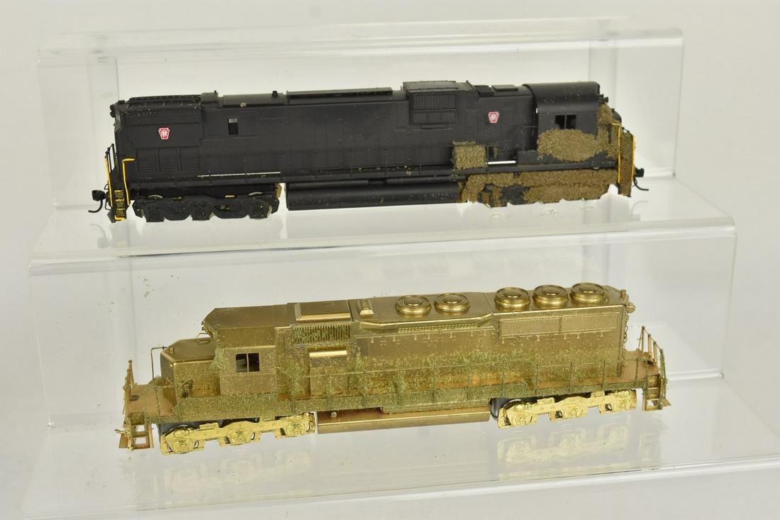 Alco Brass HO Scale S-1 & RF-16A: A pair of brass Alco HO scale trains in original packaging. Includes C-630, painted; and SD-40L. Shelf wear; discoloration present; interior padding disintegrating. Please Note: Scheerer McCulloch Auc
