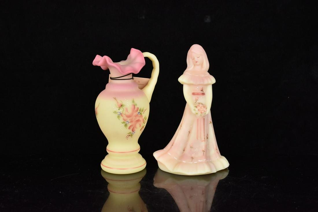 (2) Fenton Burmese: (1) 7" Fenton Burmese glass, hand painted Bridesmaid doll. Excellent condition, stamped and signed. (1) 6.5" x 3.5" Fenton Burmese glass, hand painted, pitcher. Excellent condition, signed and tagged 