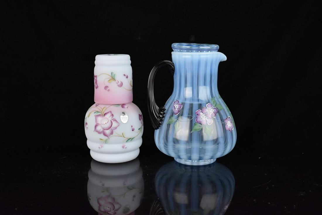 (2) Fenton "Tumble Up's": (1) 7" Fenton, blue Burmese "Tumble Up" set, from the "Glass Messenger Exclusive" series. Includes carafe and nesting tumbler. Excellent condition with tags, signed base. (1) 7.5" Blue rib optic, with