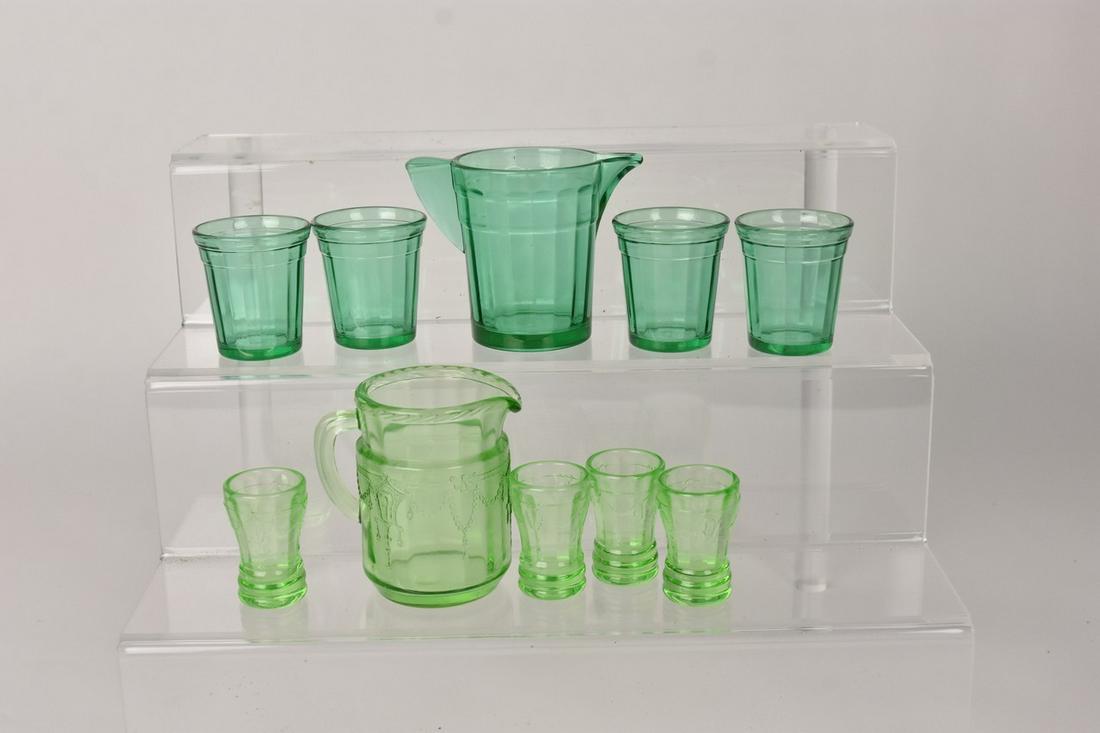 (2) 5 Piece Set Depression Glass Miniatures: (1) 5Pc Mosser Cameo green miniature 3" pitcher and 1.75" tumblers. (1) 5 piece Akro Agate miniature 2.75" pitcher and 2" tumblers. Akro Eagle embossed on base. Please Note: Scheerer McCulloch Auction