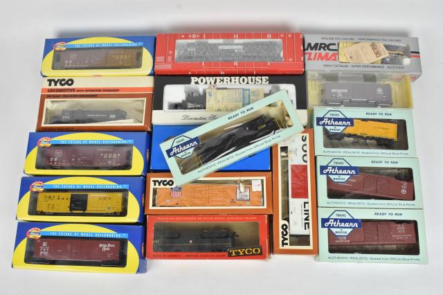 (17) HO Scale Train Cars: A collection of 17 HO scale train cars in original packaging. Includes Oriental Limited, Atlas, Kadee, Athearn, MRC Lima, and Tyco. Shelf wear and retail stickers to packaging; Tyco boxes especially d