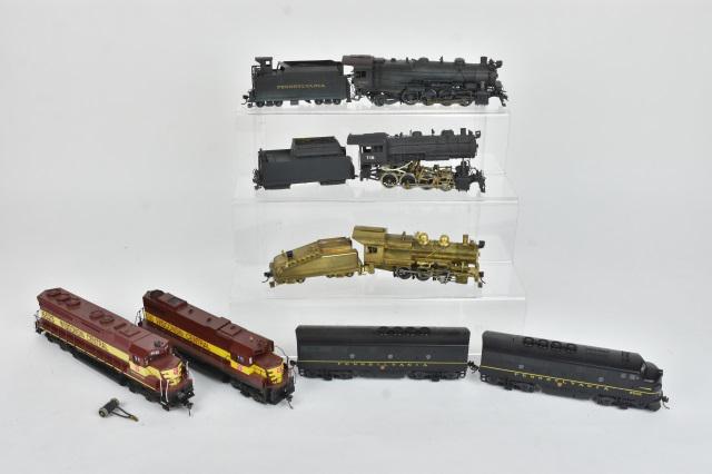 Various HO Scale Precision Models: A collection of HO scale precision models. Includes an unmarked brass 0-6-0 locomotive & tender; two plastic Wisconsin Central diesel engines marked "Ajin Korea" to their underside; a painted brass 0-