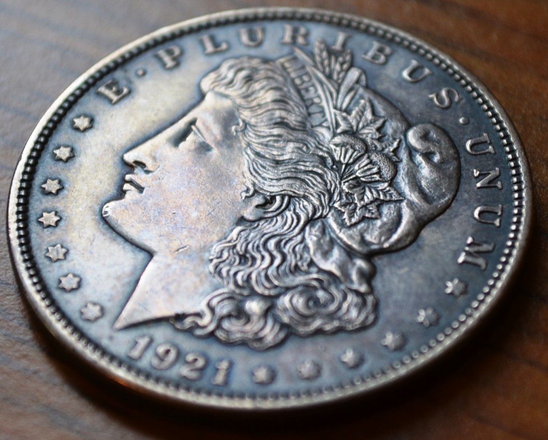 1921 Morgan dollar, 2 silver quarters & British pound: 1921 Morgan silver dollar, 2 Canadian silver quarters and a British pound.
