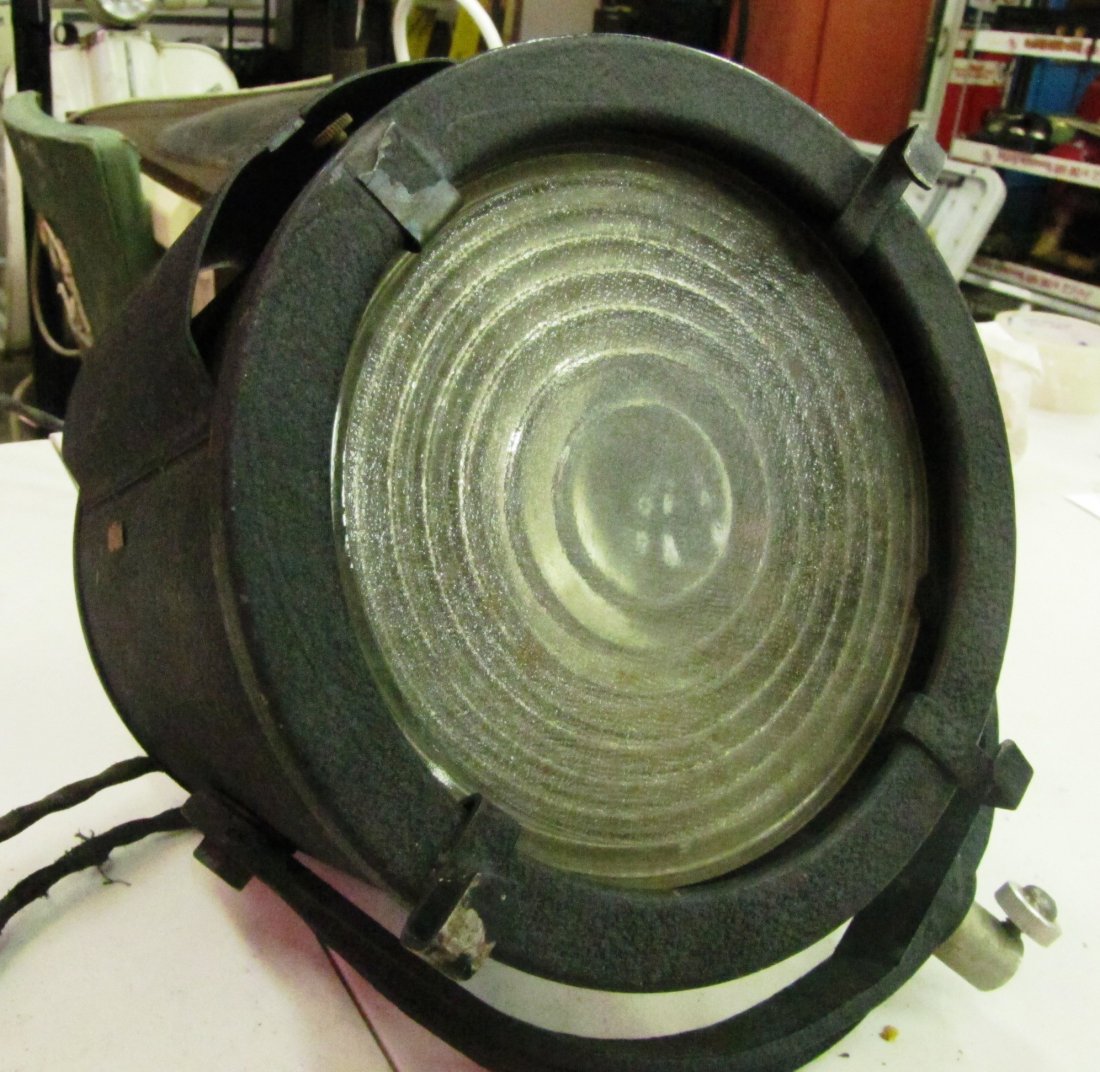 Cast Iron Base Black Stage Light: hinged cast iron base, thick glass lense, bottom base knob for sliding the light for brightness, fabric cord, on/off switch on the cord, cord has been taped, 8" long x 7" diameter, fully functioning