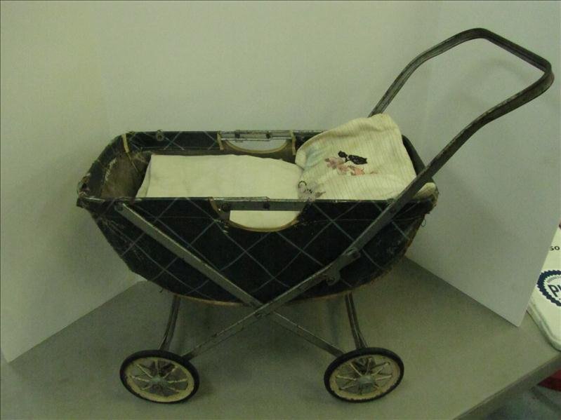 Vintage Baby Buggy with Linens: Vintage Baby Buggy with Linens Hard rubber tires with spoke framing. Has padding, pillow and blanket. This is collapsible. Some damage to the outer fabric. Measures: 18" long x 9" wide x 15" tall.