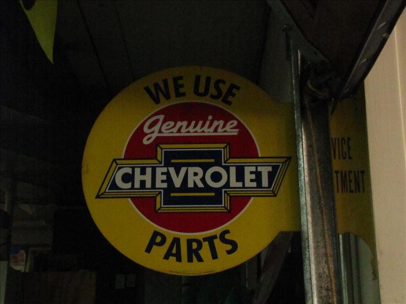 Chevrolet Service Center flange sign: Chevrolet Service Center Advertising Sign "We use genuine Chevrolet Parts Service Center" double sided sign. This measures: 18" x 12" diameter. Side bar for mounting.