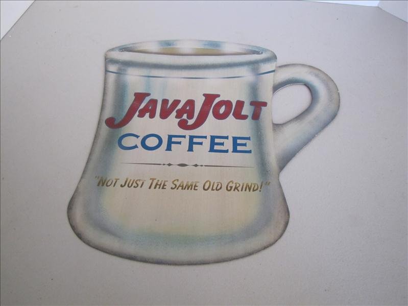 JAVA Jolt Coffee Advertising Sign: JAVA Jolt Coffee Advertising Sign This advertising sign has "JAVA Jolt Coffee, Not just the same old grind" on the front. This measures 13.75 x 12.5". Eyelets at top corners for hanging.