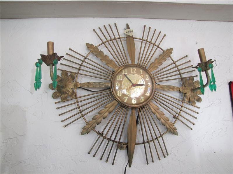 Vintage Zenith Wall Clock: Vintage Zenith Wall Clock This clock was made by Zenith. This is from the mid-century modern era. This has two candelabras on each side with plastic crystals. This is electric powered and fully functi