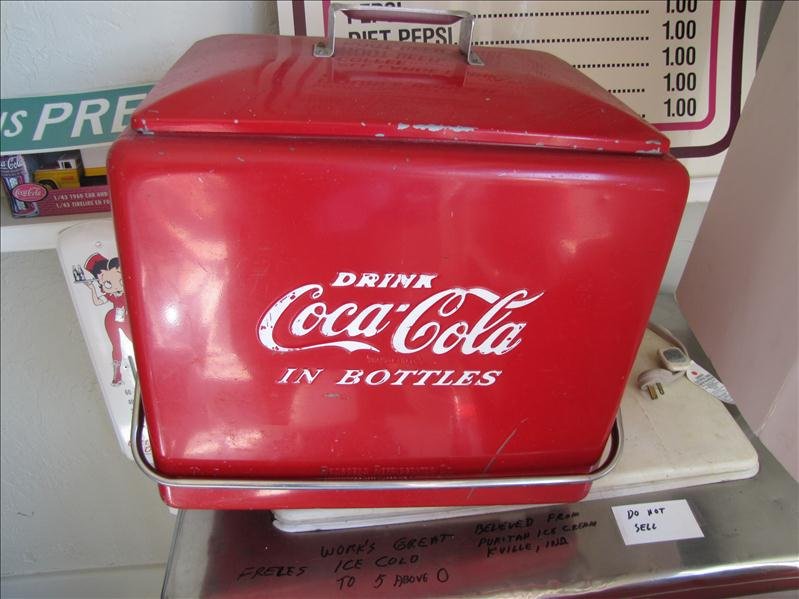 Coca Cola Portable Cooler: Coca Cola Portable Cooler This has movable handle with side bottle opener. Removable lid to a removable ice tray. This is insulated. Logos on front and back. Made by Progress Refrigerator Co Louisvill