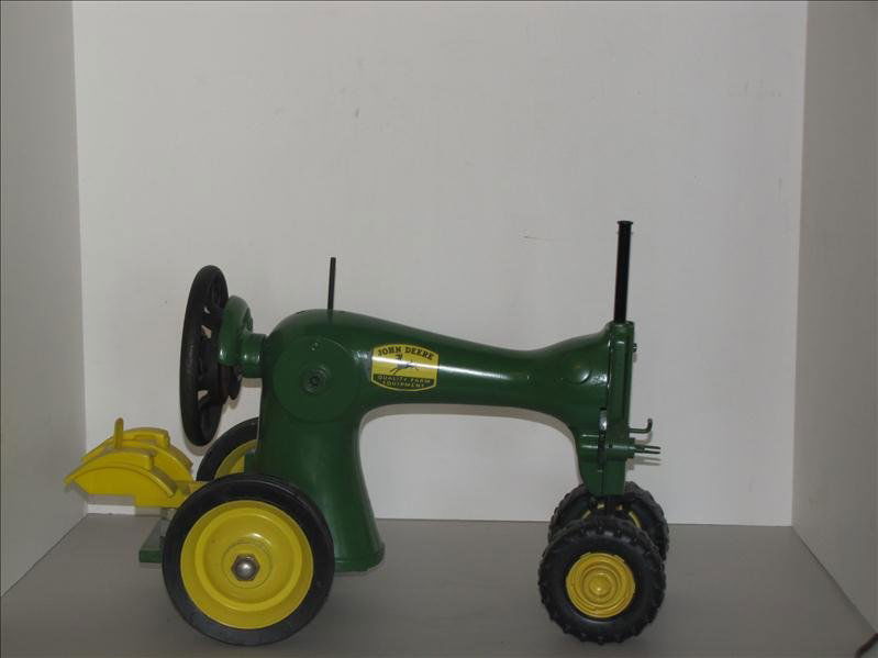 Custom Made John Deere Singer Tractor: Custom Made John Deere Singer Tractor Custom made John Deere Tractor. Originally this was an antique black Singer sewing machine. This has been redesigned to be a tractor. Has the original gold Singer