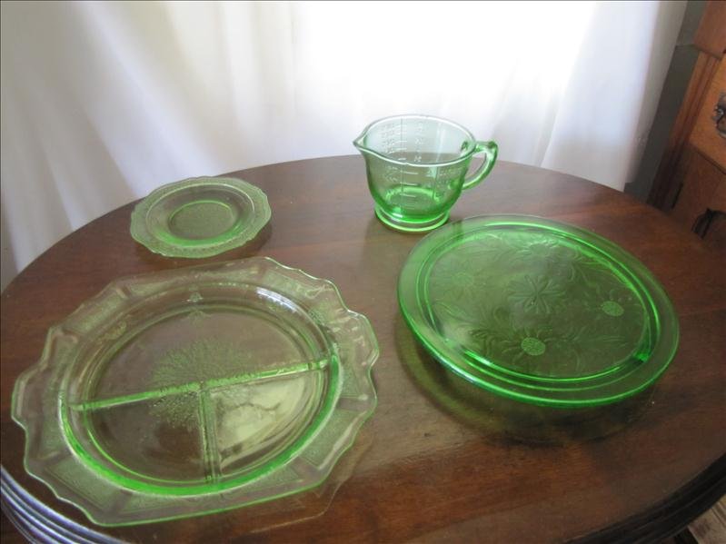 Lot of 4 Green Glass Depression Pieces: Lot of 4 Green Glass Depression Pieces This lot includes 4 pieces of green glass: 1 round raised, footed flower pattern cake plate 10" x 1.25", 1 - 2 cup mixing and measuring cup 3.5" tall, 1 small sa