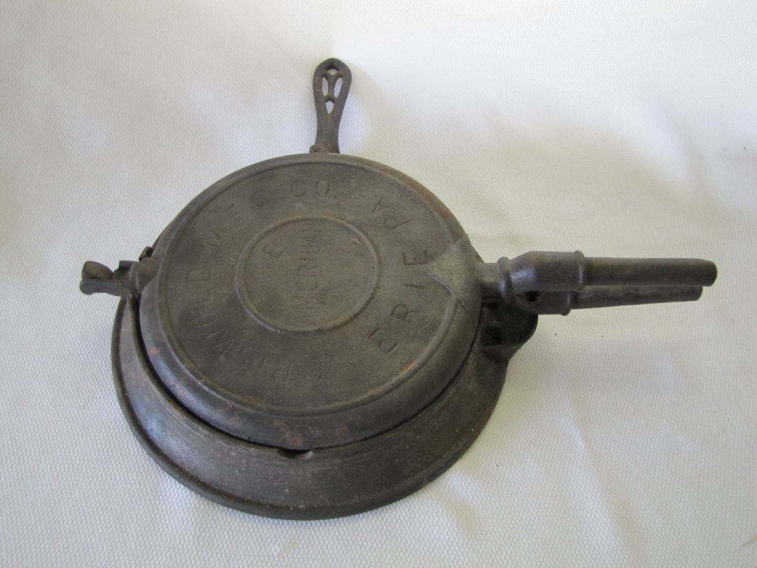 Griswold Cast Iron Waffle Pan: Griswold Cast Iron Waffle Pan This was made by Griswold and is named "The American". This was produced in Erie, PA. This includes both the waffle iron and base. This measures 7.75" diameter of the iro