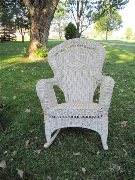 White Wicker Rocking Chair: White Wicker Rocking Chair This is a white wicker high back rocking chair. It has brown wicker tinting. The chair measures 42" tall x 29" x 32".