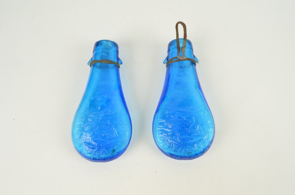 Pair of early embossed glass flasks: Ducks in water scene, 7 inches tall, very good condition. From Franlkin Oliver Johnson estate