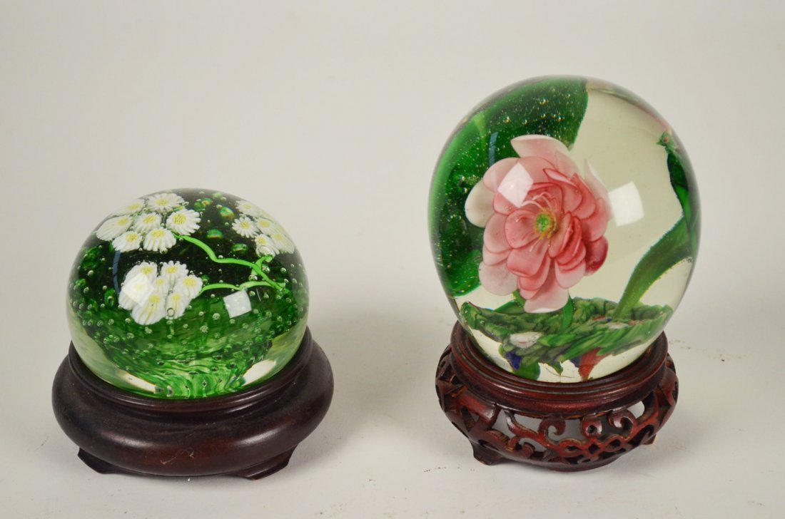 Pair of Flower Glass Balls/ Paper Weights: Pair of Flower Glass Balls/ Paper Weights. The tall decorative paper weight has a beautiful large pink flower and sits on a cut out design wooden base, measuring 5.25 inches tall on base. The paper we