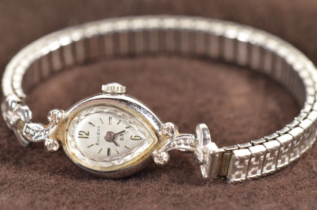 Bulova Ladies Diamond & Gold Plate Watch: This ladies watch by Bulova is 10k rolled gold plate and has 4 diamond settings around the face. Face of the watch is in a tear-drop shape. Total weigh of this watch is 15g. 23 Jewels.