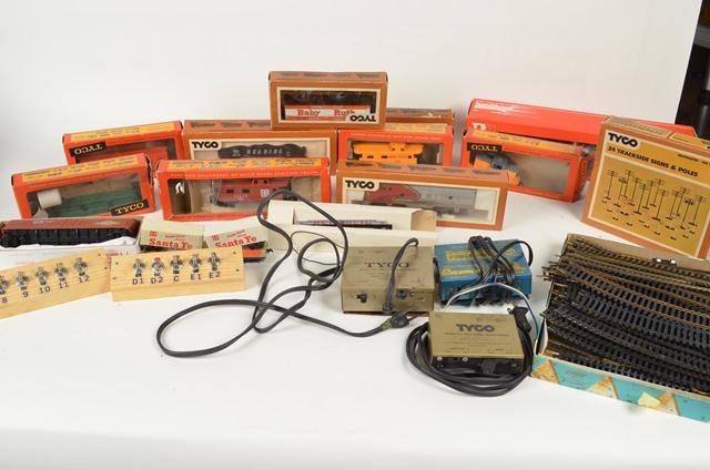 Large Group of Tyco Train Cars and Switches: This group of train cars includes several Tyco cars (many in their original packaging), train switches, railroad track and other train cars. Also included is a boxed set of trackside signs and poles.