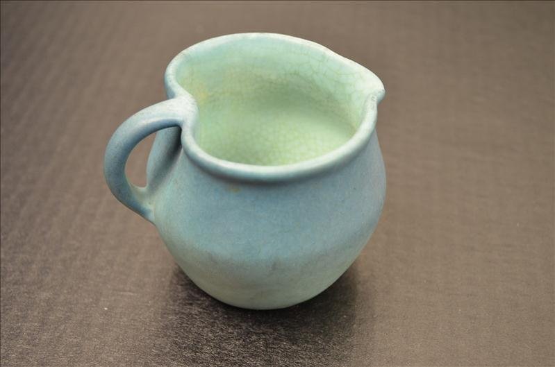 Van Briggle Pottery Small Pitcher: Van Briggle Pottery Small Pitcher Offered is a small pitcher creamer of Van Briggle pottery. Glazed with the normal green-blue teal colors. Crazing on the inside of the pitcher. The piece is in very g