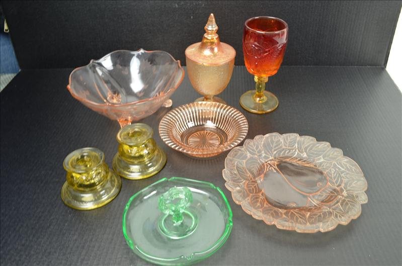 8 Pcs. Of Assorted Glassware: 8 Pcs. Of Assorted Glassware Included is some marigold, green, and pink depression glassware and also an amberina goblet. Footed pink depression bowl. Pair of yellow depression glass candle holders.