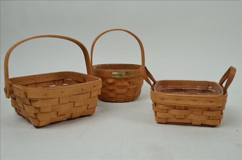 (3) Longaberger Baskets: (3) Longaberger Baskets 1991 Longaberger basket, Leather handle basket is a 1990, and the Christopher Columbus discovery basket from 1992.
