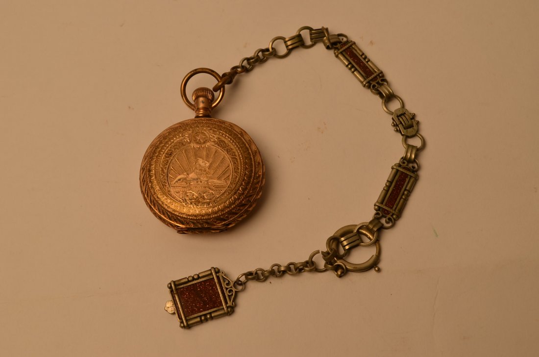Large Atlas Watch Co. Pocket Watch: Hunter watch case and chain. Winding stem is free. Mascot is marked on the iner shell of the watch case. Heavy watch chain with no apparent markings. Case has a depiction of a lion with a star above i