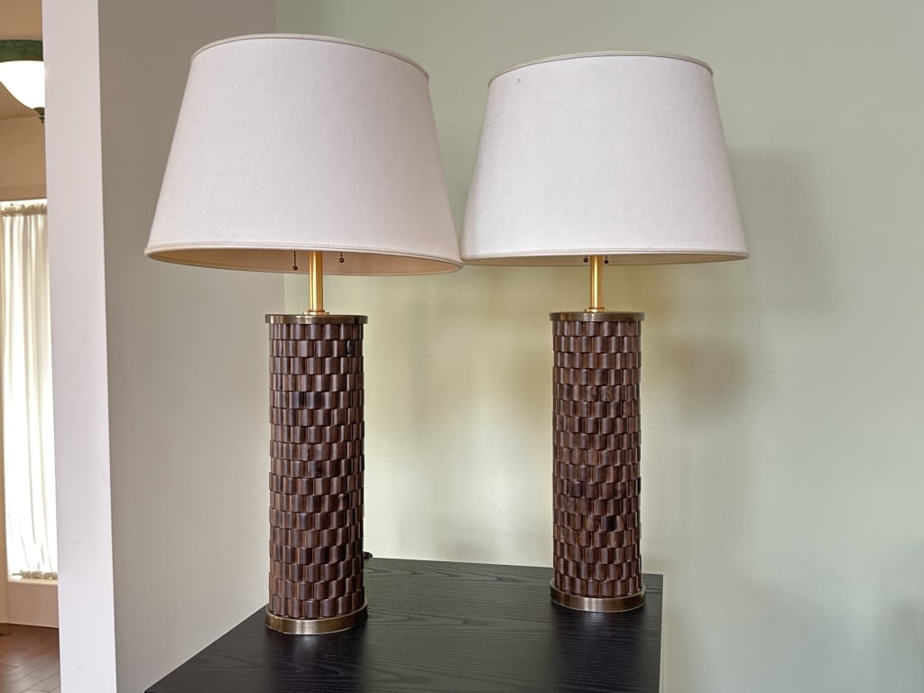 Pair Baker Furniture Thomas Pheasant Lamps: Pair of Thomas Pheasant for Baker Furniture PH020-B table lamps, made in Italy. Feature a cylindrical column with offset wood ribbing in a deep dark walnut finish, accented by antique brass hardware.