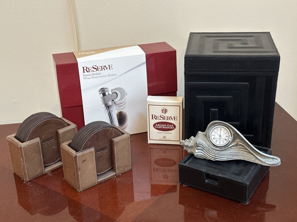 Coach Coasters, ReServe Wine Preserve System: Pewter Kirk Stieff Shell shaped quartz clock, 6 1/2in L. (10) Coach brand coasters. ReServe Premier Modular wine preservation system: includes the reserve adaptor, reserve regulator. An unused box of