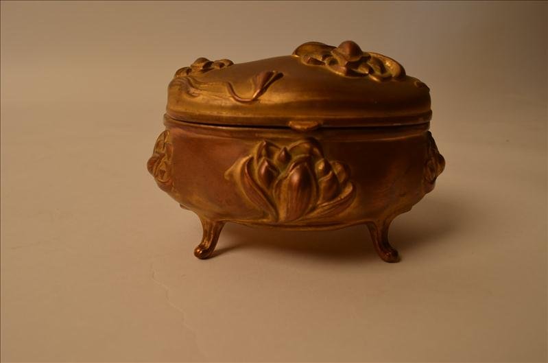 Victorian Jewelry Casket: Victorian Jewelry Casket Cast metal construction with a hinged lid. Heavily embossed flower motif design. Still retains the interior fabric. Marked on the bottom "J.B. Signifies the Best". This piece