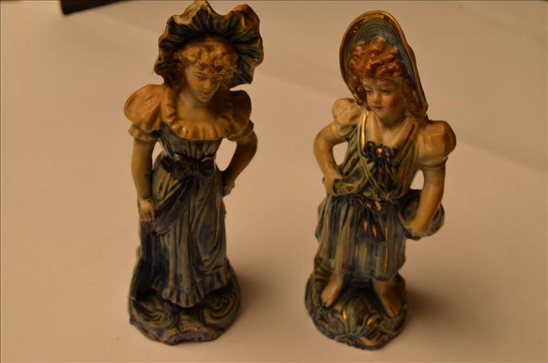 (2) Bisque & Flow Blue Figurines: (2) Bisque & Flow Blue Figurines The figurines measure 8" tall and do not match. The ladies dresses are very indicative of flow blue. Both figurines are included in this lot. One figure is holding an