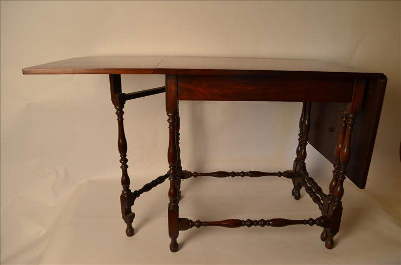 Walnut Drop Leaf Table: Walnut Drop Leaf Table Dovetail joints on the drawer. Wonderful spindle gate leg construction. Opened up the table measures 59.5" wide and 23" deep. The height is 28". There is some slight sun fading