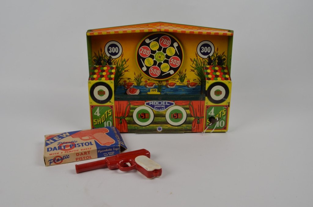 Wyandotte Toys Tin Litho Shooting Gallery: Vintage childrens wind up toy. Winds up and works great. The belt on the back is missing. Comes with the original plastic dart pistol still in original box.