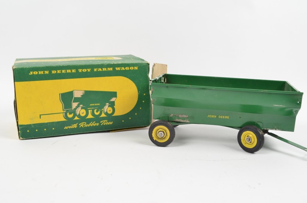 John Deere Toy Farm Wagon: Child's John Deere wagon toy comes in original box. Good condition with some rust inside wagon and chipped paint.